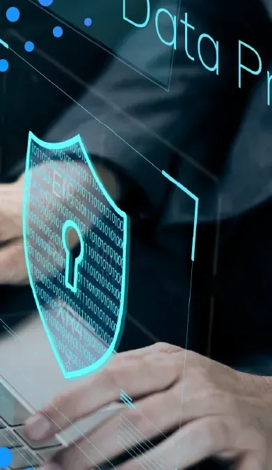 Hands on a laptop with a digital security shield