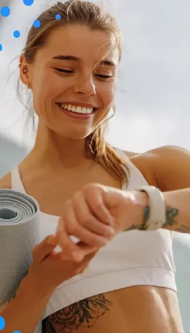 Woman smiling while checking her smartwatch