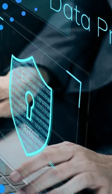 Hands on a laptop with a digital security shield