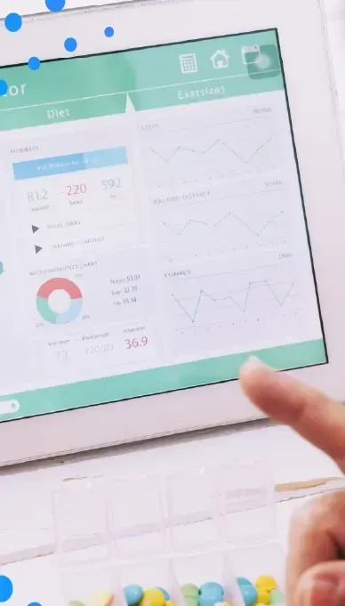 Hand pointing at charts on a tablet