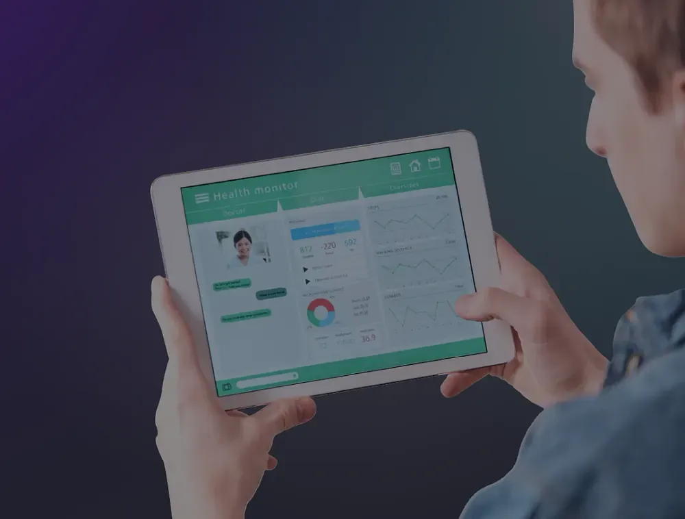 Person reviewing a health monitoring dashboard on a tablet