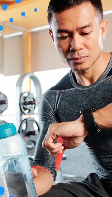 Man checking a fitness tracker at the gym