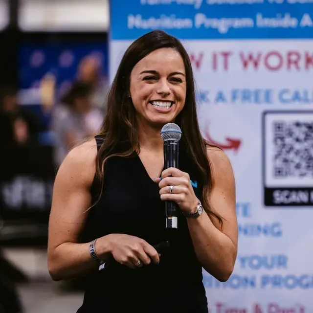 Nicole Aucoin, founder and CEO of Healthy Steps Nutrition, speaking on stage with a microphone