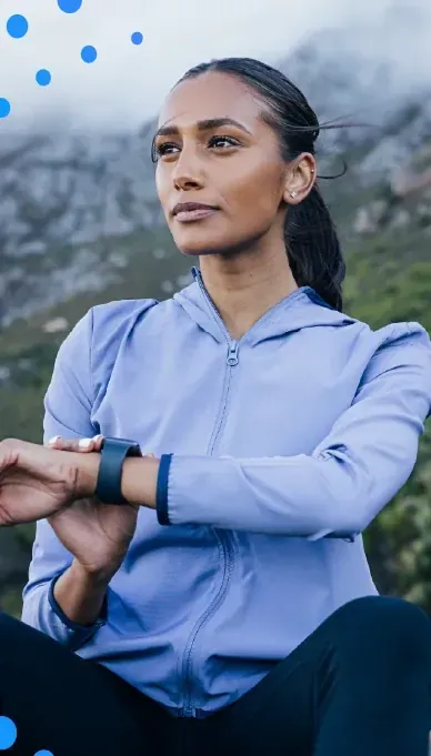 Woman checking her smartwatch outdoors