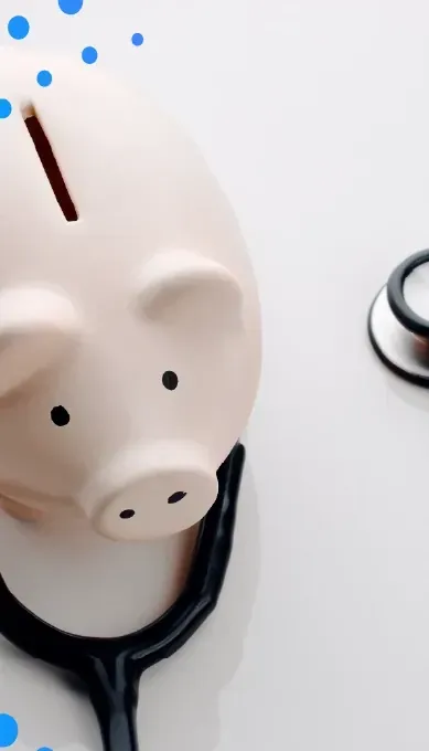 Piggy bank next to a stethoscope